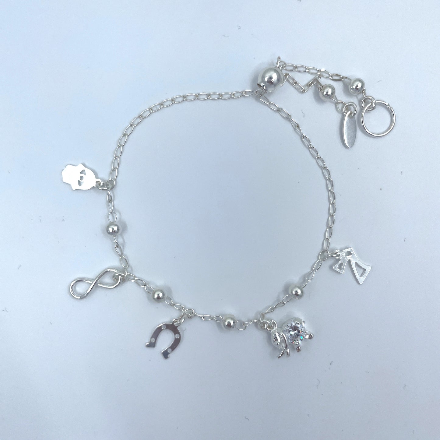 Pulsera de Plata de Buena Suerte con Infinito, Siete, Herradura, Mano y Elefante con Zirconia.