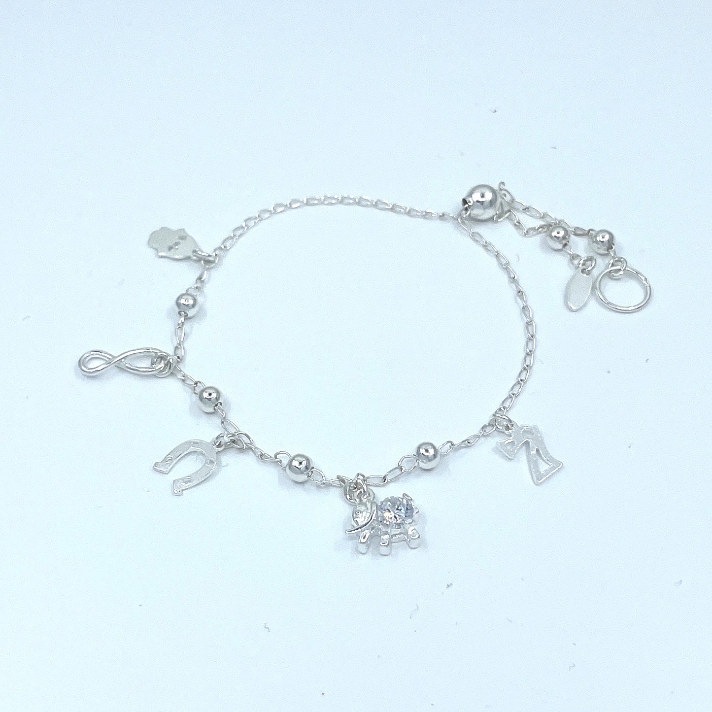 Pulsera de Plata de Buena Suerte con Infinito, Siete, Herradura, Mano y Elefante con Zirconia.